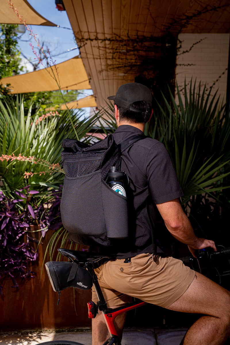 Backpacker puts a Bear Vault Bear Canister into a ULA CDT Backpack