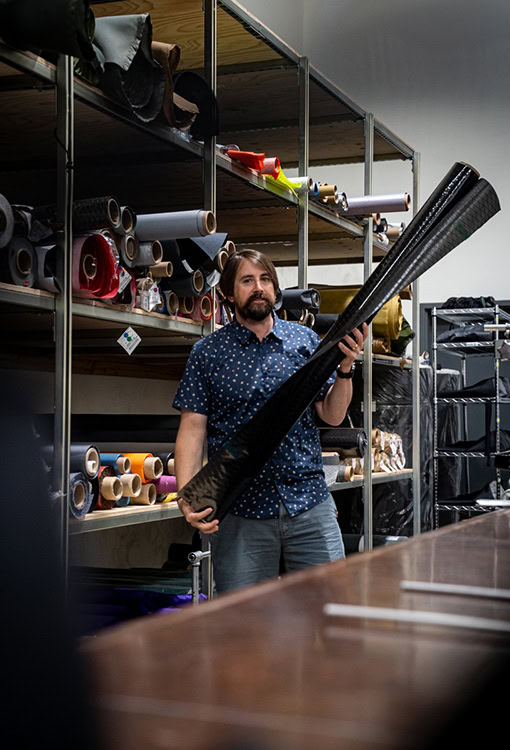 Backpacker puts a Bear Vault Bear Canister into a ULA CDT Backpack