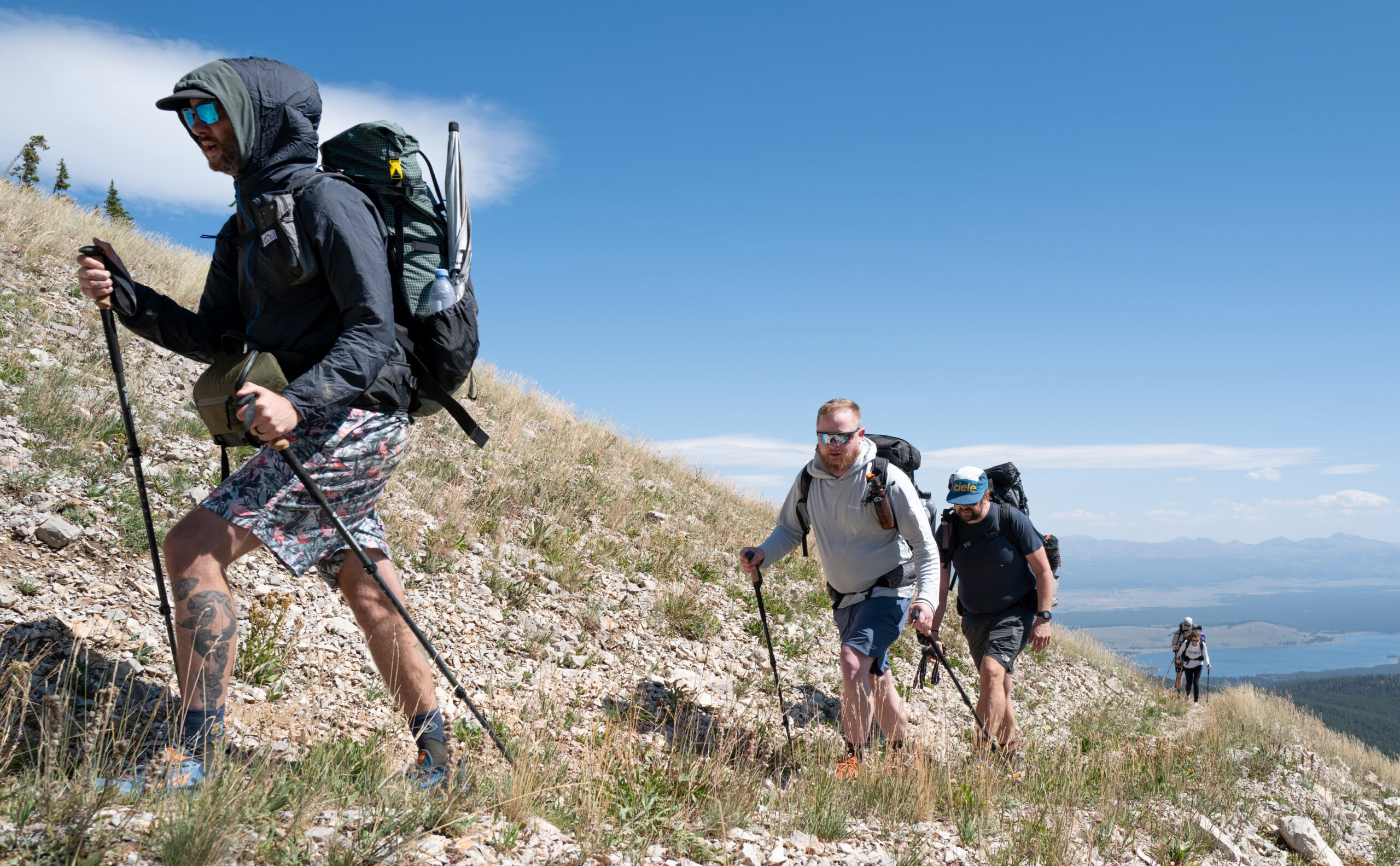 A group of hikers walk along a trail